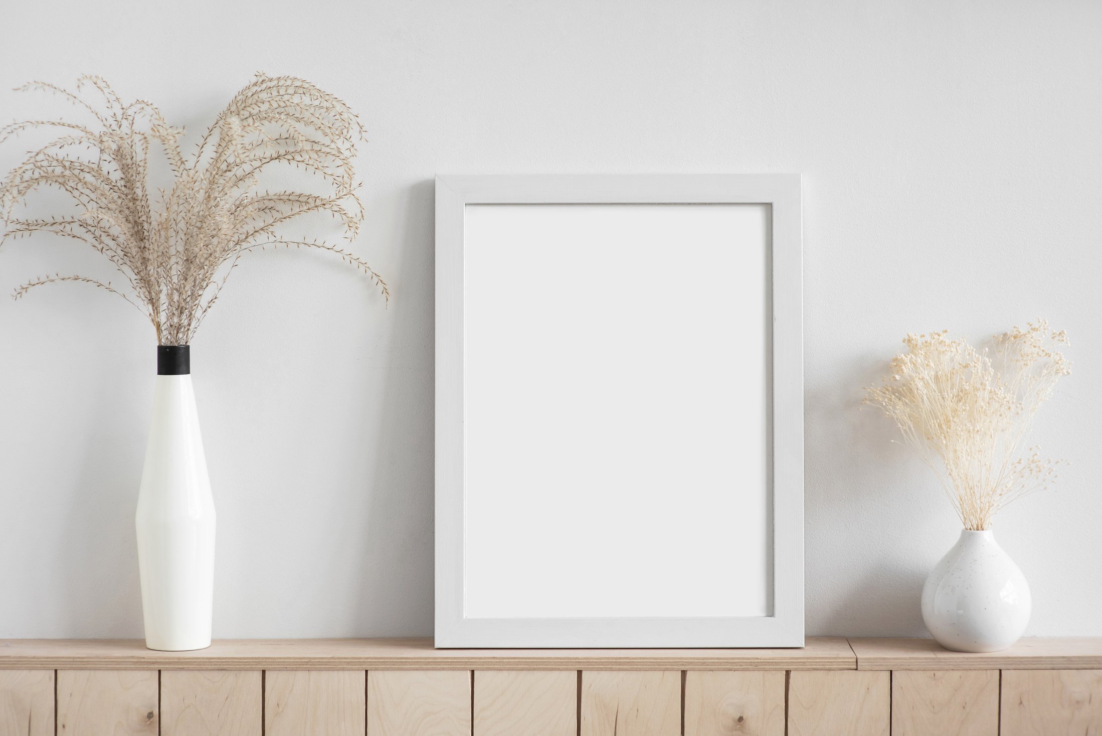 Blank picture frame mockup on white wall. Living room design